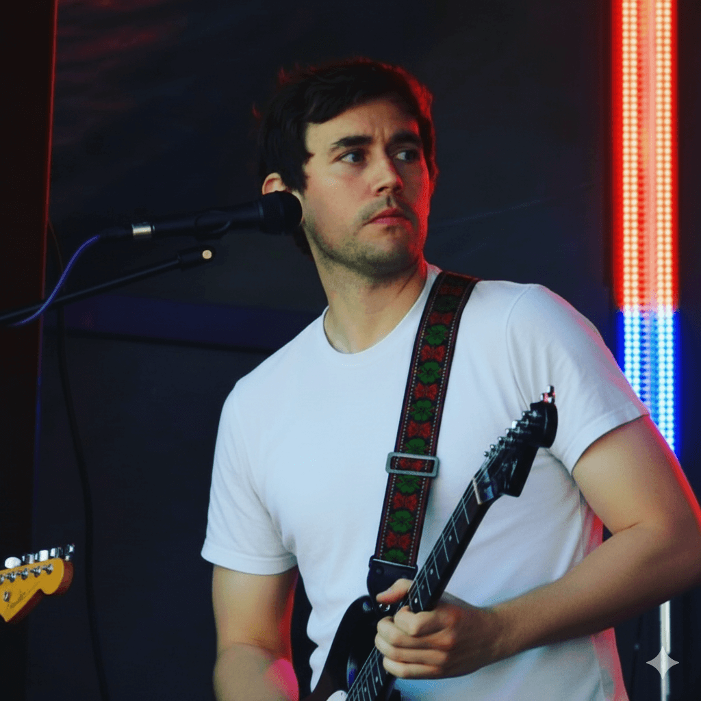 Close-up of guitarist performing with dramatic lighting