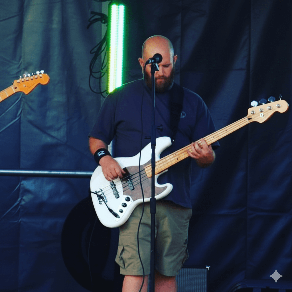Bass player performing with green stage lighting