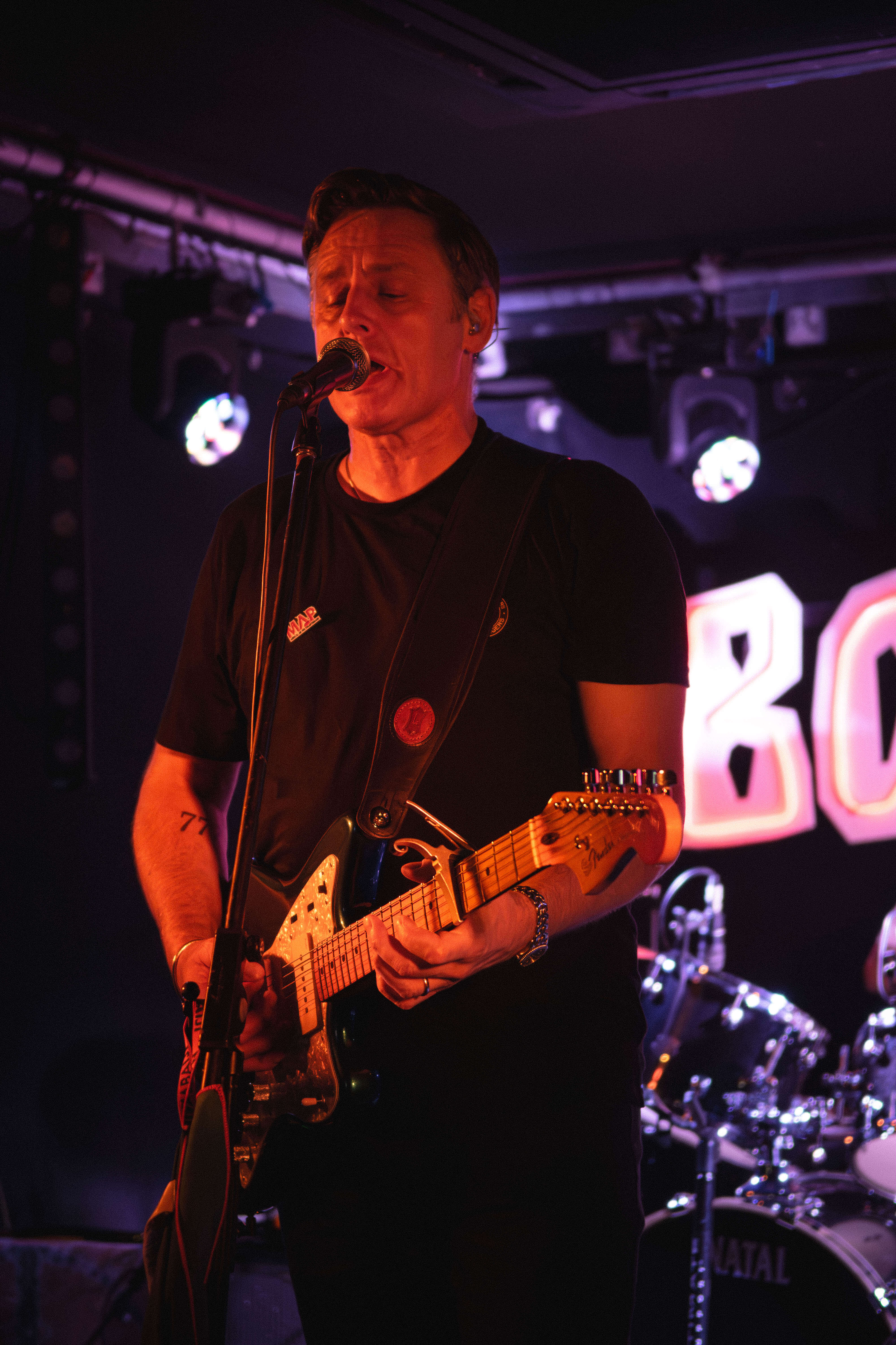 The Passengers lead vocalist performing at microphone indie rock cover band UK