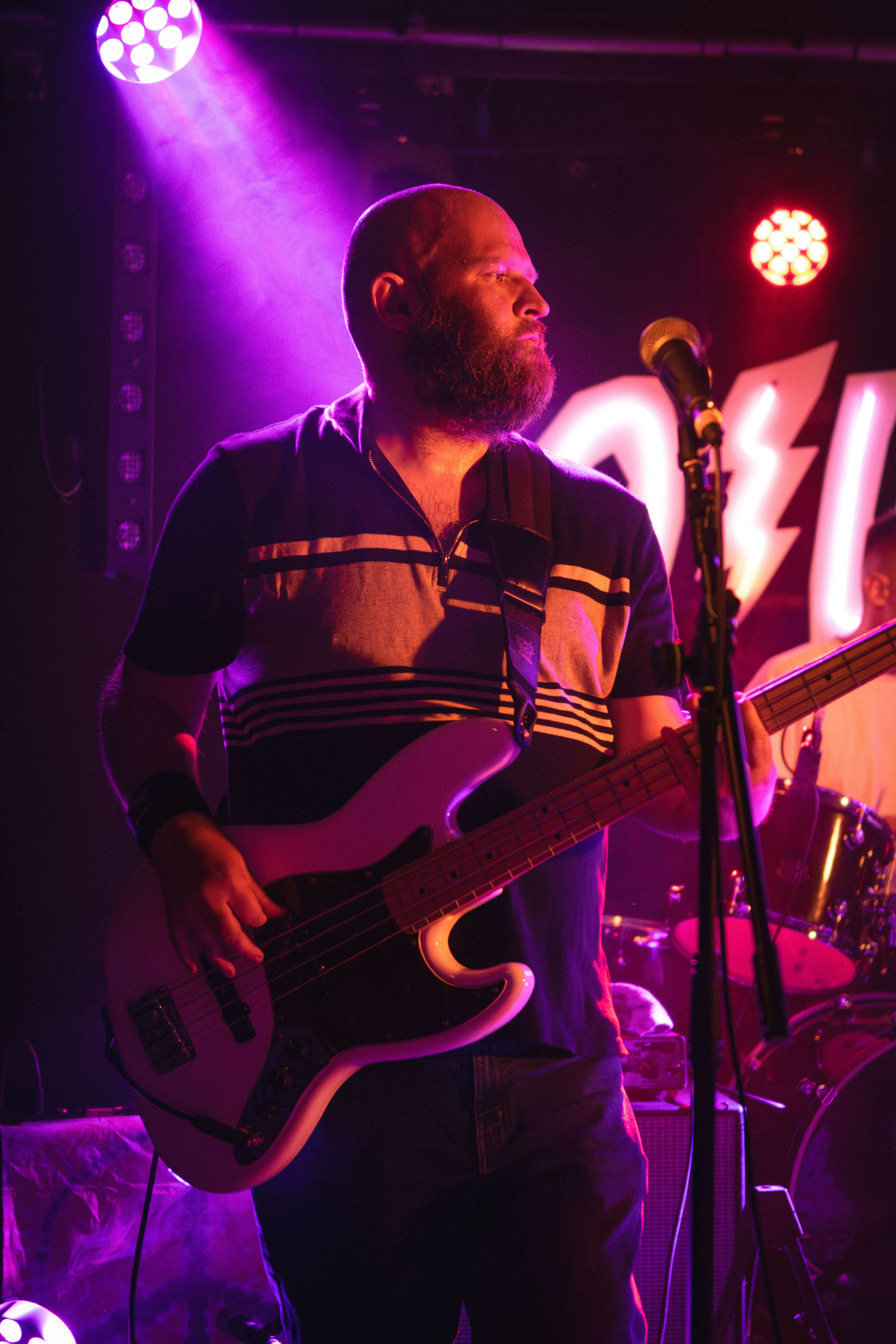The Passengers bass player live performance purple stage lighting Surrey wedding band