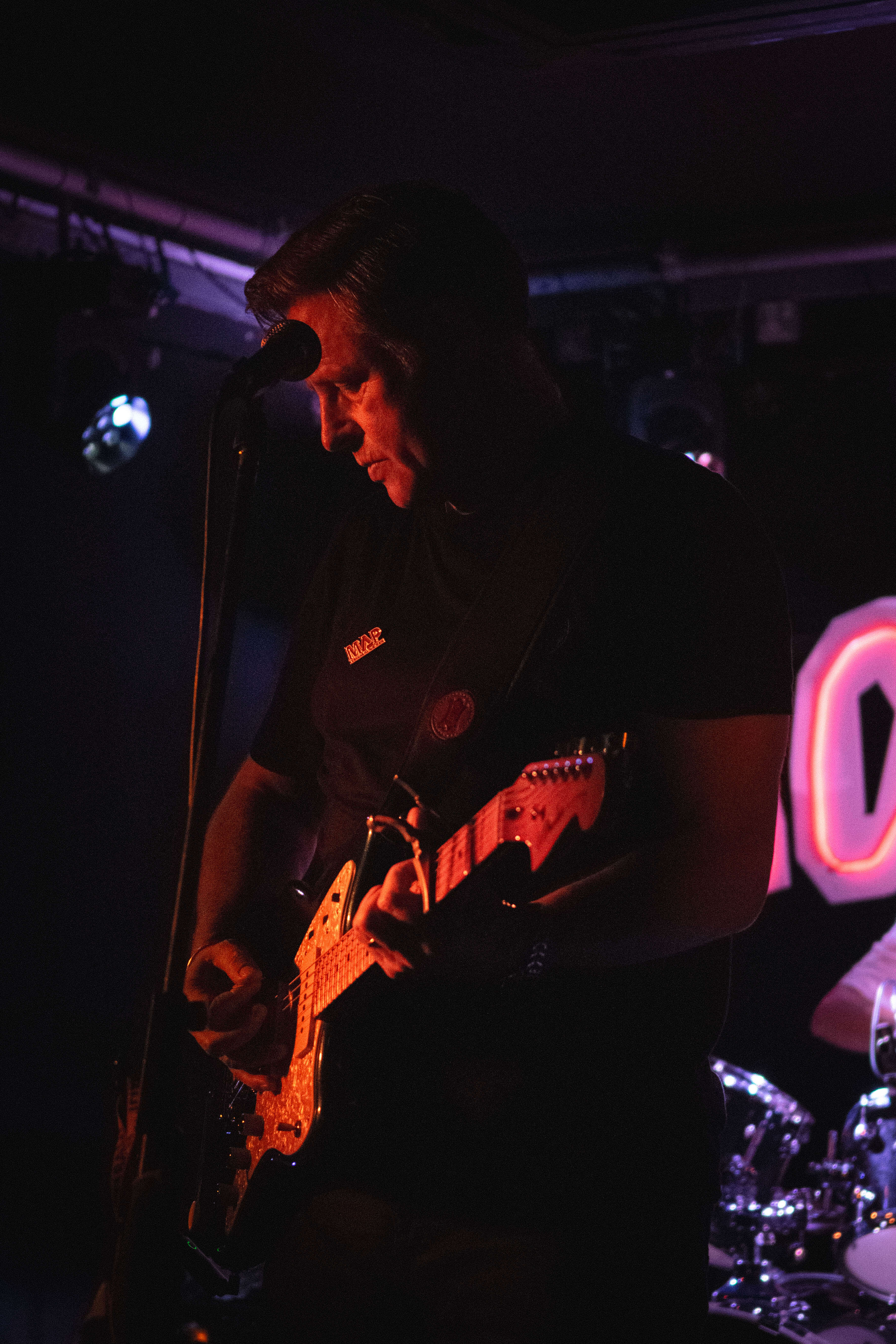 Guitarist with red stage lighting