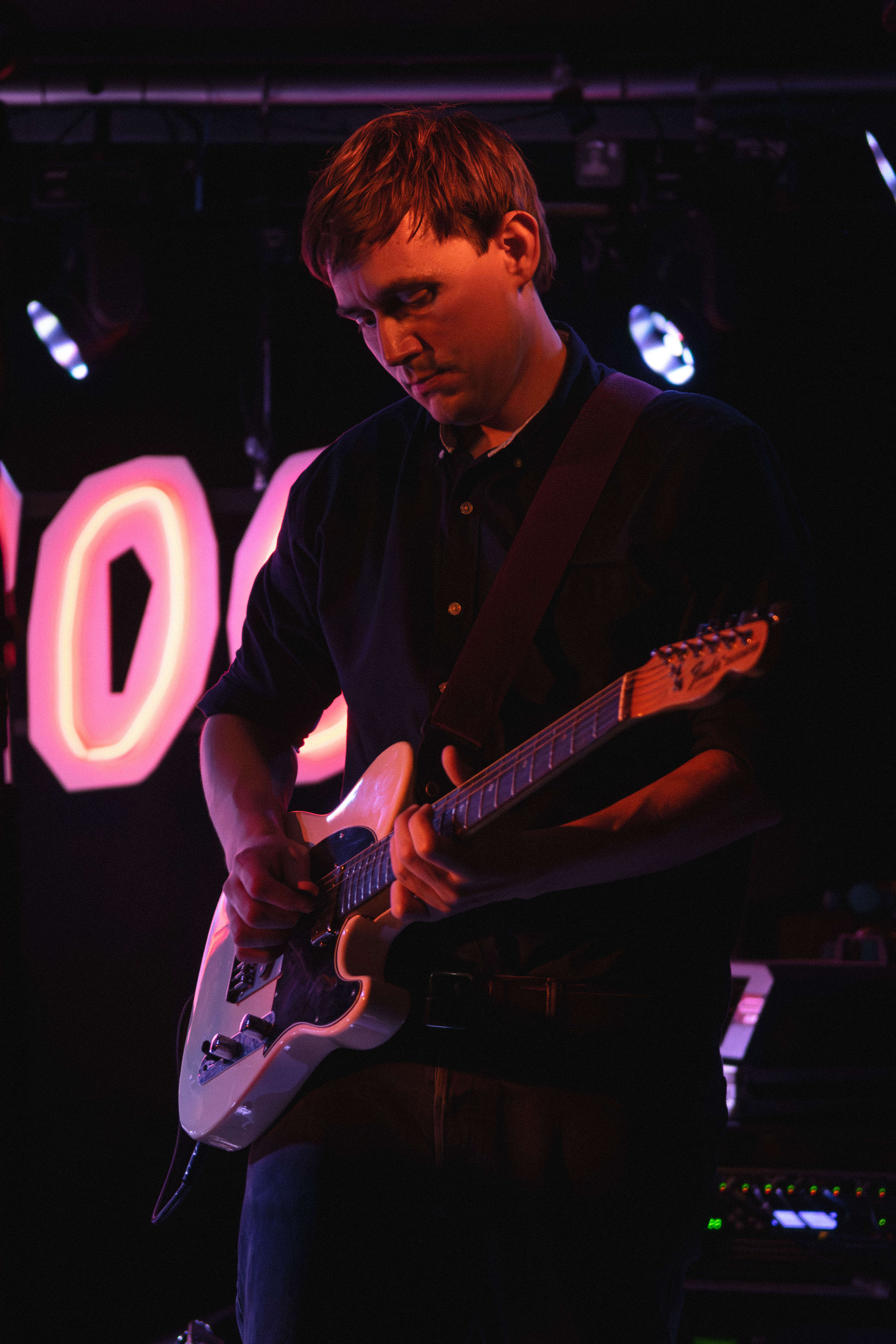 Lead vocalist and guitarist with dramatic purple lighting
